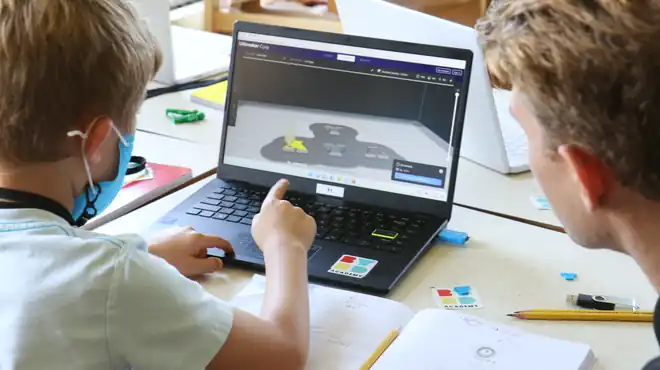 A camper models a part on a laptop