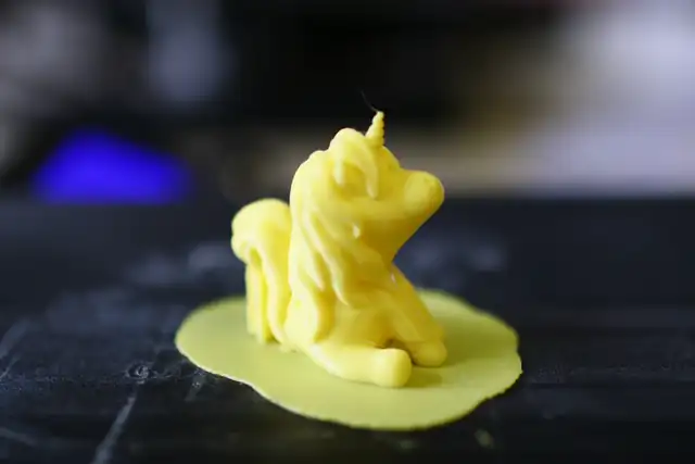 A finished yellow print on the build plate