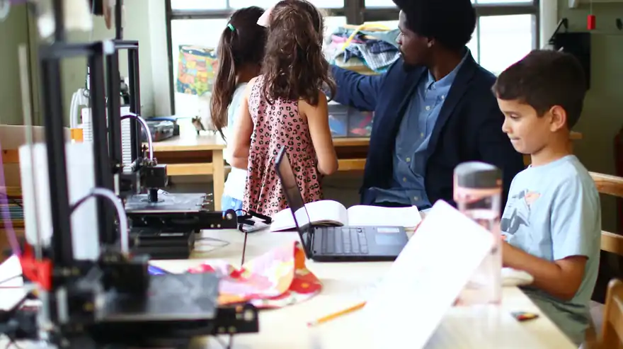 Makers at work in a room of 3D printers