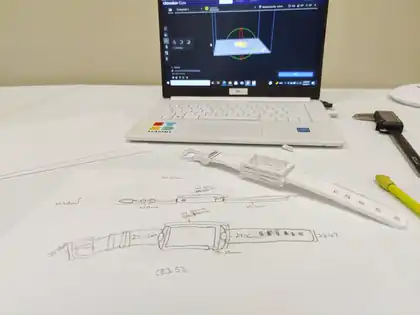 The drawing beside the laptop and the printed band